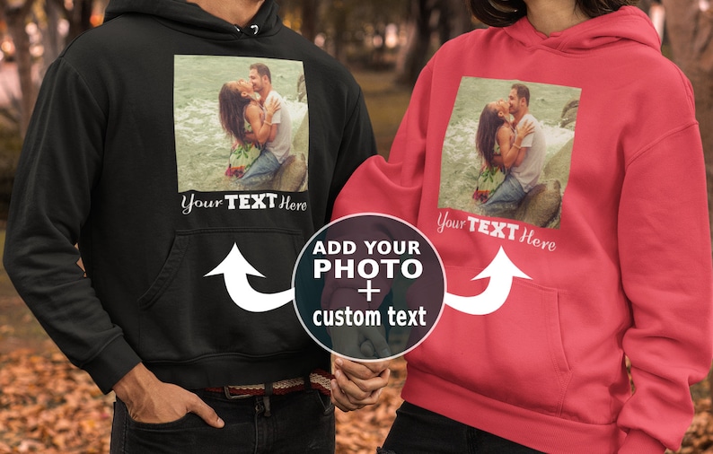 May include: Two black and red hoodies with a photo upload area and the text "Add your photo + custom text" on the front. The hoodies have a pocket on the front and a white arrow pointing to the photo upload area. The text "Your Text Here" is below the photo upload area.