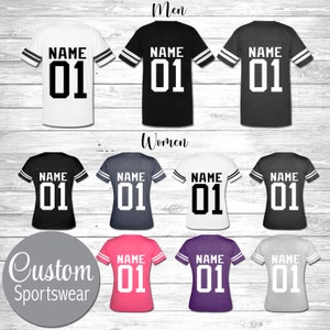 May include: A set of nine customizable t-shirts with a football jersey design. The shirts are available in a variety of colors, including white, black, gray, pink, purple, and heather gray. The shirts feature a white number "01" and the word "NAME" printed on the back.