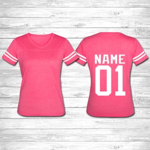 May include: Pink jersey with white stripes on the sleeves and a white number "01" and the word "NAME" on the back.