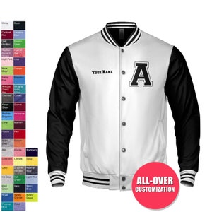 May include: A white and black baseball jacket with a black letter 'A' on the front. The jacket has a zipper closure and a ribbed collar, cuffs, and waistband. The text 'YOUR NAME' is embroidered on the left side of the jacket. The text 'ALL-OVER CUSTOMIZATION' is printed on the bottom of the jacket.
