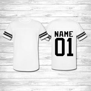 May include: White jersey with black stripes on the sleeves. The back of the jersey has the text "NAME 01" in black.