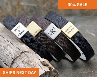 May include: Five leather bracelets with personalized metal plates. The bracelets are black and brown with white stitching. The metal plates are engraved with names, initials, and coordinates. The text "Nate & Chloe", "1 COR 13:7", "LRJ", and "30.4120°N -91.1838°W" are visible.