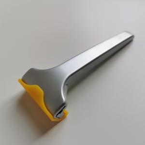 May include: A silver and yellow disposable razor with a yellow plastic handle.