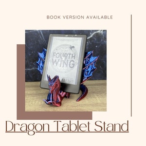 May include: A red and blue 3D printed dragon tablet stand. The dragon is holding a black e-reader with the book "The Fourth Wing" by  Rebecca Yarros on the screen.