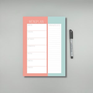 May include: A pink and blue dry erase board with the words "MEN&Uuml;PLAN" and "EINKAUFLISTE" written on it. The board is divided into two sections, one for a meal plan and one for a shopping list. There are lines for writing on both sections.