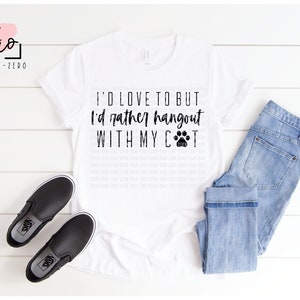 May include: White t-shirt with black text that reads "I'd love to but I'd rather hangout with my cat" and a paw print.