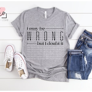 May include: A grey t-shirt with the text "I may be wrong but I doubt it" in black. The shirt is styled with blue jeans and white trainers. The image also includes the words "studio SEVEN-FOUR-ZERO" and file type icons.