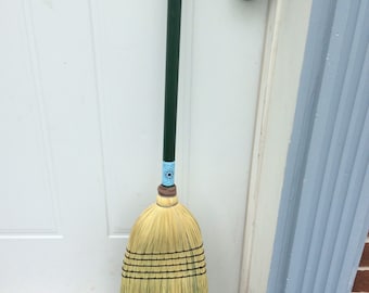 Heavy outdoor broom with green painted handle