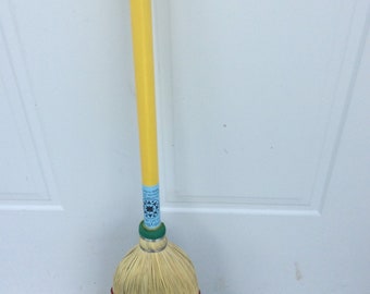 Children size broom with yellow handle