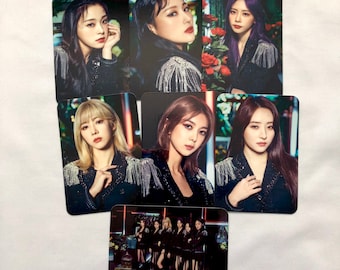 May include: A collection of rectangular photo cards featuring a group of women. Each card displays a different portrait of the women, with some cards showing individual portraits and others showing the group. The women are wearing black outfits with silver fringe.