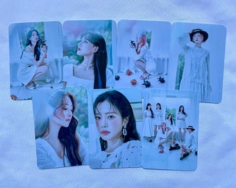 May include: Set of 8 photo cards featuring a K-pop girl group in white dresses. The cards feature individual portraits and a group photo. The cards are printed on high-quality paper and are perfect for fans of the group.