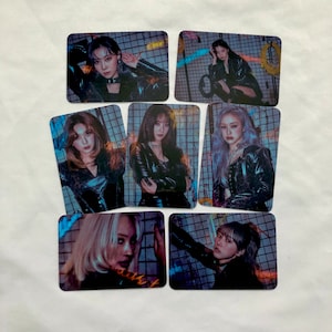 May include: Set of six photo cards featuring six different women in black leather jackets. The women are posed in various poses against a backdrop of a chain link fence and colorful graffiti.
