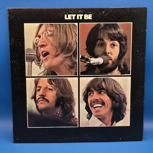 May include: A square vinyl record cover titled LET IT BE featuring four individual photographic portraits of the band members arranged in a grid. The background is black, and each portrait is framed in a white border, showing the musicians.