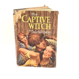 May include: The cover of a vintage paperback book titled "The Captive Witch" by Dale Van Every. The cover features a colorful illustration of a man and two women in a romantic scene.