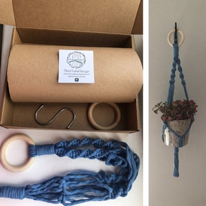 May include: A blue macrame plant hanger with a wooden ring and a small metal pot holding a plant. The image also shows the packaging, including a cardboard box, a metal hook, and a wooden ring.