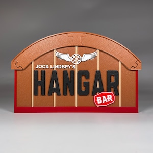 May include: A brown and red sign with a white airplane logo and the text "Jock Lindsey's Hangar Bar".