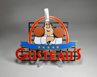 May include: A red, white, and blue sign with a cartoon chef holding two loaves of bread. The sign says "Gusteau's" in gold letters.