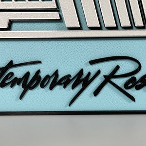 May include: A blue and white sign with the text "Contemporary Resort" in black cursive lettering.