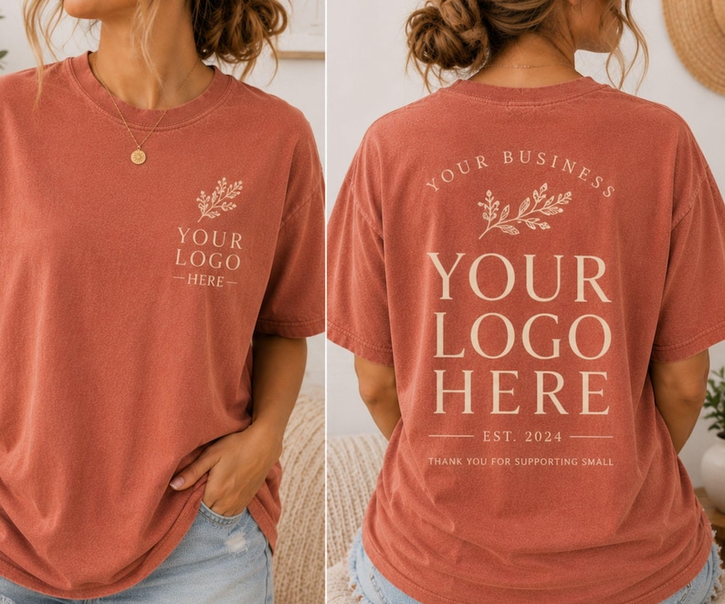May include: A brick red t-shirt featuring a small cream-colored floral graphic and the text YOUR LOGO HERE on the front left chest. The back displays a larger version of the same floral graphic with the text YOUR BUSINESS, YOUR LOGO HERE, EST. 2024, and THANK YOU FOR SUPPORTING SMALL.