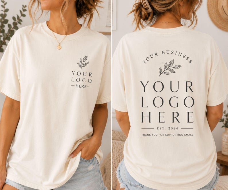 May include: An off-white short-sleeve t-shirt featuring a small black botanical graphic and the text "YOUR LOGO HERE" on the front left chest, and a larger version of the same graphic and text on the back with "EST. 2024" and "THANK YOU FOR SUPPORTING SMALL".