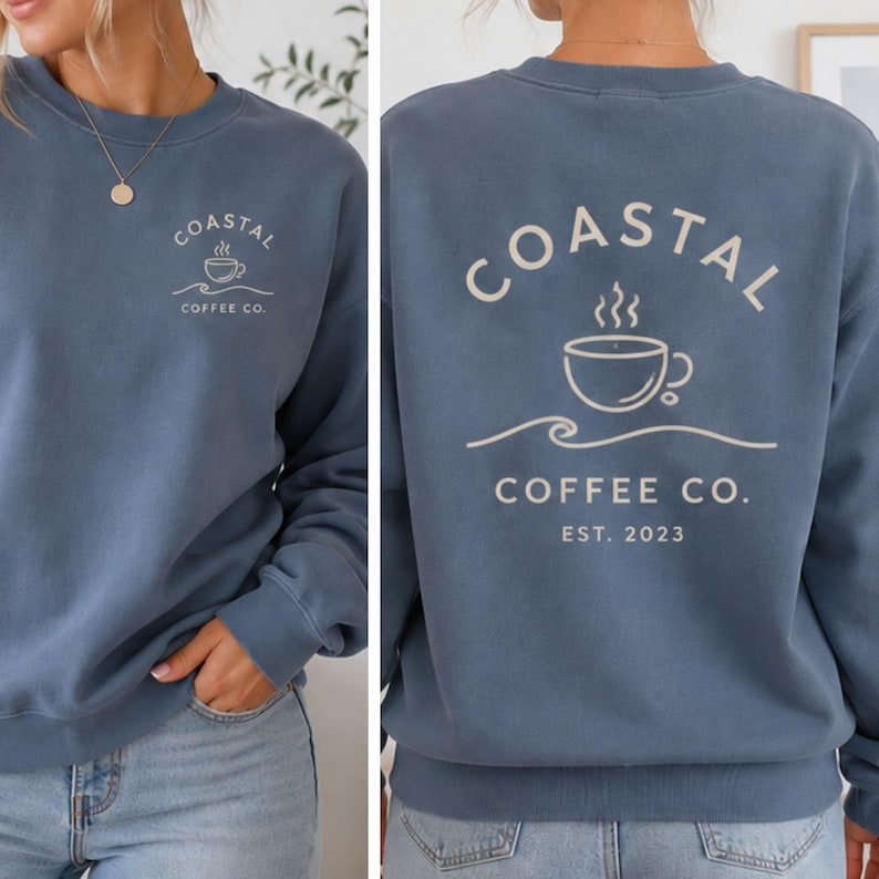 May include: A blue crewneck sweatshirt featuring a small graphic on the front left chest and a large graphic on the back. Both graphics display a coffee cup icon above a wave line with the text Coastal Coffee Co. The back includes Est. 2023.