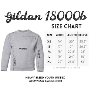 May include: A grey Gildan 18000b youth crewneck sweatshirt size chart. The graphic displays a light grey long-sleeve sweatshirt with dashed lines indicating width, length, and sleeve measurements, alongside a table listing sizes XS to XL in inches.