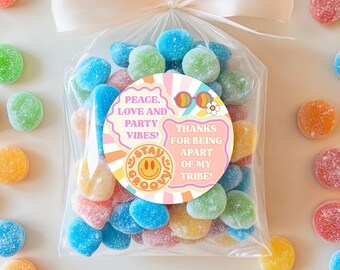 May include: A clear plastic bag filled with colorful candy, tied with a pink ribbon. A round sticker with a pink background and white text reads "Peace, Love and Party Vibes!" and "Thanks for being apart of my tribe!"