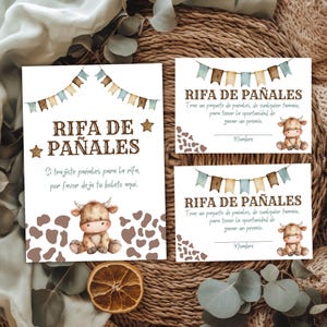 Puede incluir: Tres tarjetas de rifa para baby shower con una ilustración de vaca en acuarela. Las tarjetas tienen texto en español, incluyendo "Rifa de Pañales" e instrucciones. El diseño incluye colores marrón, azul y beige con detalles de banderines y estrellas.