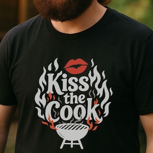 A man with a beard is smiling and holding a grill with food on it, standing in front of a wooden structure with string lights.