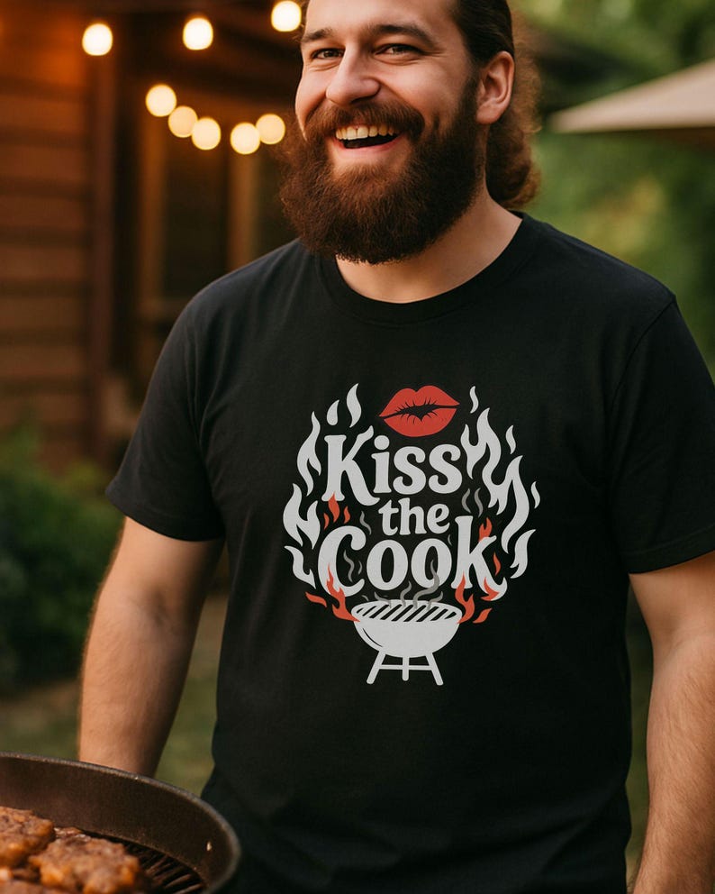 A man with a beard is smiling and holding a grill with food on it, standing in front of a wooden structure with string lights.
