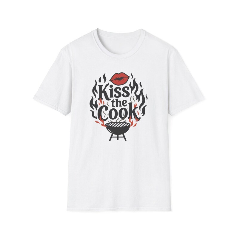 A white t-shirt with a graphic design featuring a pair of lips and flames surrounding the text "Kiss the Cook".