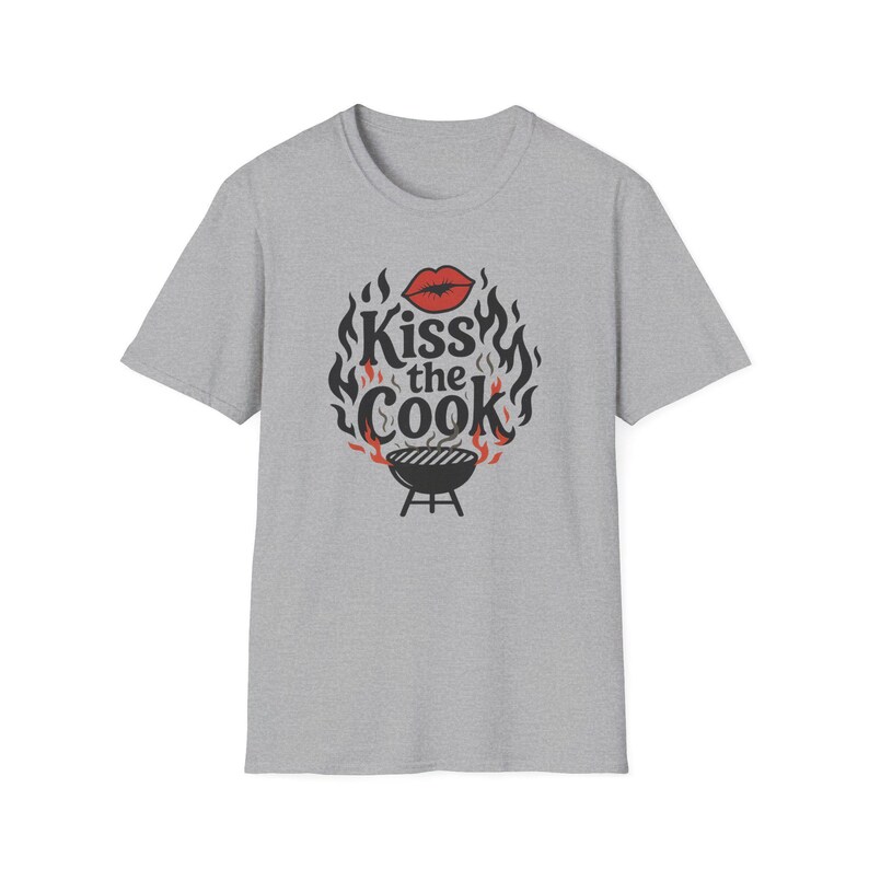A gray t-shirt with a graphic design featuring a pair of lips and flames surrounding the text "Kiss the Cook".