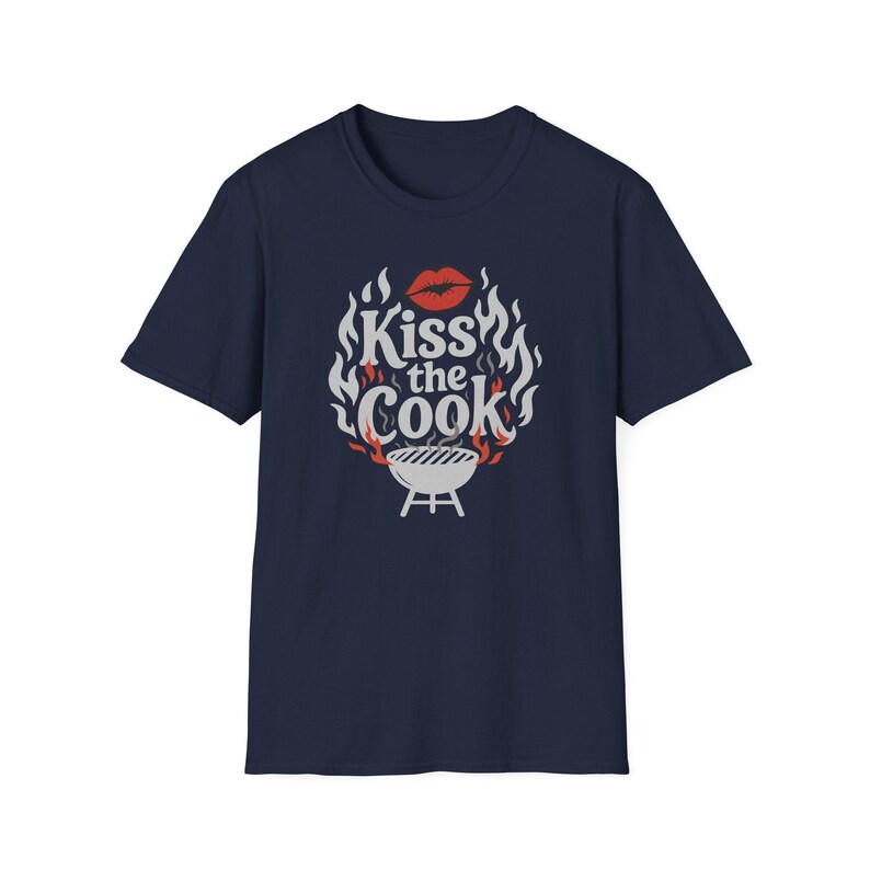A navy blue t-shirt with a graphic design featuring a pair of lips and flames surrounding the text "Kiss the Cook".