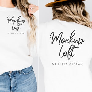May include: White long-sleeve sweatshirt with the text "Mockup Loft STYLED STOCK" printed on the front and back.