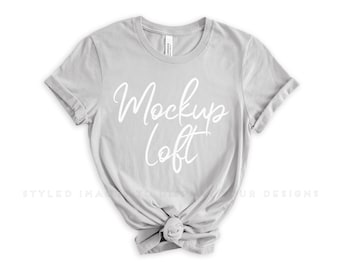 May include: A light gray t-shirt with a white "Mockup Loft" design printed on the front. The shirt is made of a soft, comfortable fabric and has a relaxed fit.