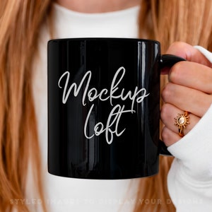 May include: A black ceramic mug with a white inscription that reads "Mockup Loft".