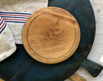 vintage round bread board with simple carved edge hatching and burn mark, well used with lots of wear, kitchen decor, as is