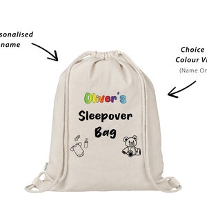 May include: A white drawstring bag with the text "Oliver's Sleepover Bag" in rainbow letters. The bag has a black and white illustration of a baby onesie and a bottle, and a black and white illustration of a teddy bear.