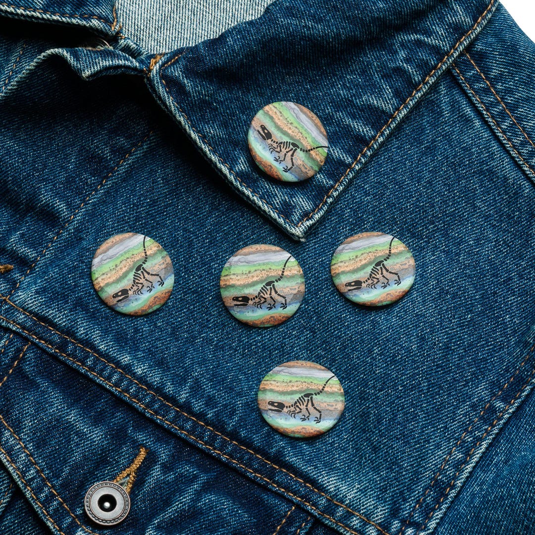 Poverty Button Raptor Raptor Fossil Button Pin – Dinosaur Skeleton on Watercolor Earth Layers ...
