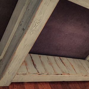 May include: A whitewashed wooden console table with a single shelf. The table has a rustic, distressed look and is made of reclaimed wood.