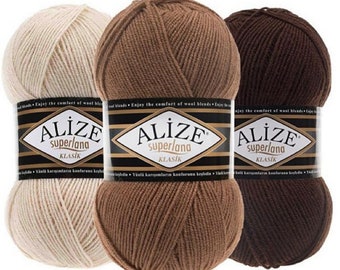 May include: Three skeins of Alize Superlana Klasik yarn in cream, medium brown, and dark brown. Each ball features a black paper label with the brand name Alize, the product name Superlana Klasik, and the text Enjoy the comfort of wool blends.