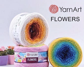 May include: Three colorful YarnArt Flowers yarn skeins. One is white, orange, and brown; another is pink; and the third is yellow, blue, and green. The YarnArt logo and the word "FLOWERS" are visible.