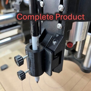 May include: A black and white pen is held in a black 3D printed pen holder attached to a black machine. The pen holder has two black knobs that can be used to adjust the pen's position. The machine is labeled "Complete Product".