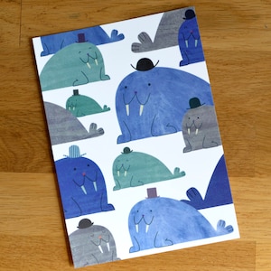 May include: A rectangular print with a repeating pattern of cartoon walruses. The walruses are in shades of blue, grey, and green, each wearing a small hat. The background is white.