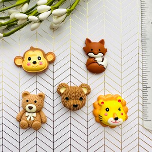 May include: Five colorful animal figurines, including a monkey, fox, bear, teddy bear, and lion. The figurines are made of plastic and have a cartoonish style. They are perfect for adding a touch of whimsy to any craft project.