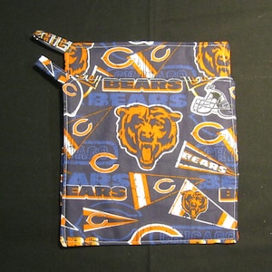 May include: A blue and orange pot holder with the Chicago Bears logo and the words "Bears" and "Chicago".