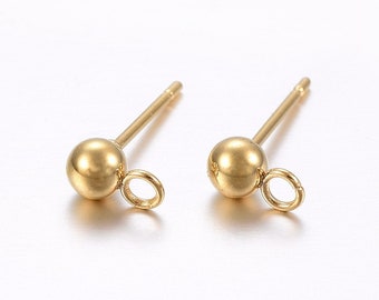 May include: Two gold-toned earring posts with a small ball at the top and a jump ring attached to the ball.