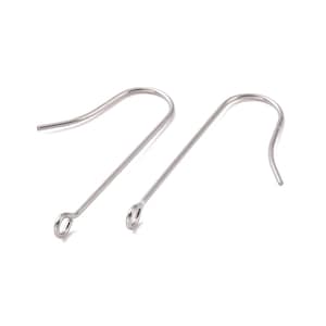 May include: Two silver earring hooks with a small loop at the top. The hooks are made of metal and are designed to be used with earrings.