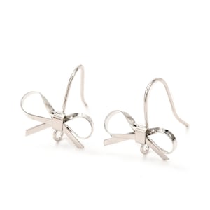 May include: A pair of silver bow earrings. Each earring has a bow design with a hook for pierced ears. The earrings are shown against a white background, emphasising their delicate and elegant appearance. These earrings are a stylish accessory.