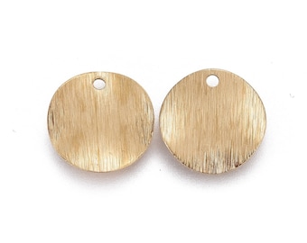 May include: Two gold-colored metal circles with a brushed finish and a small hole at the top.